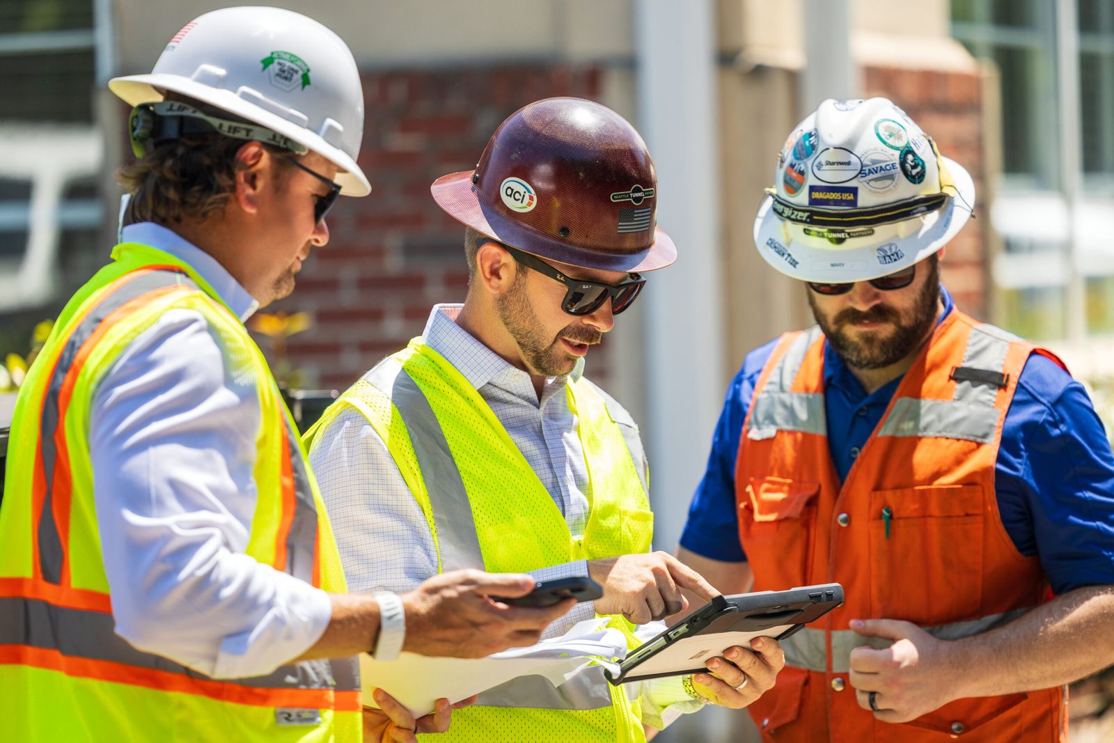 Josh Tolbert reviewing plans with crew members on a job site