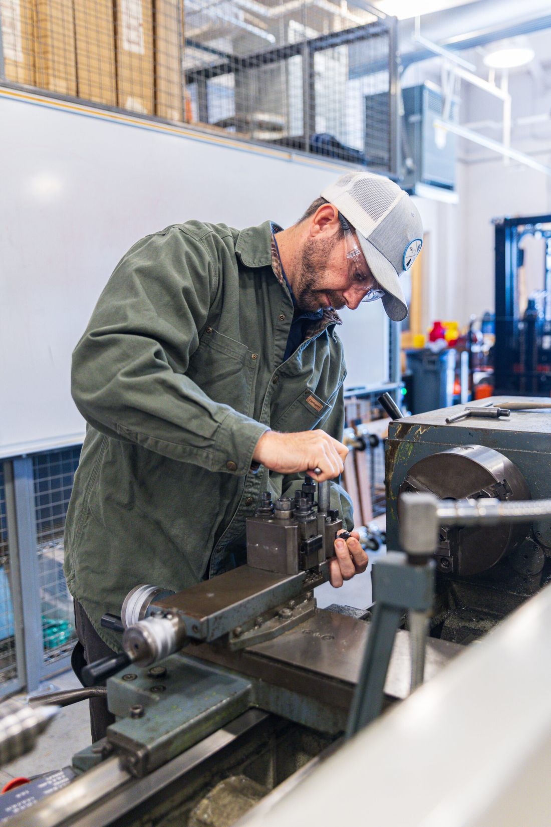 Josh Tolbert setting up a metal lathe in a machine shop