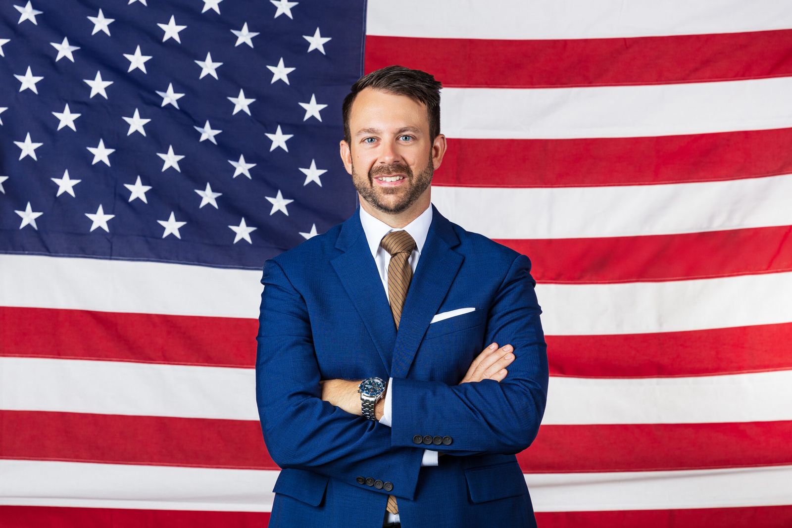 Dr. Josh Tolbert in front of an American flag